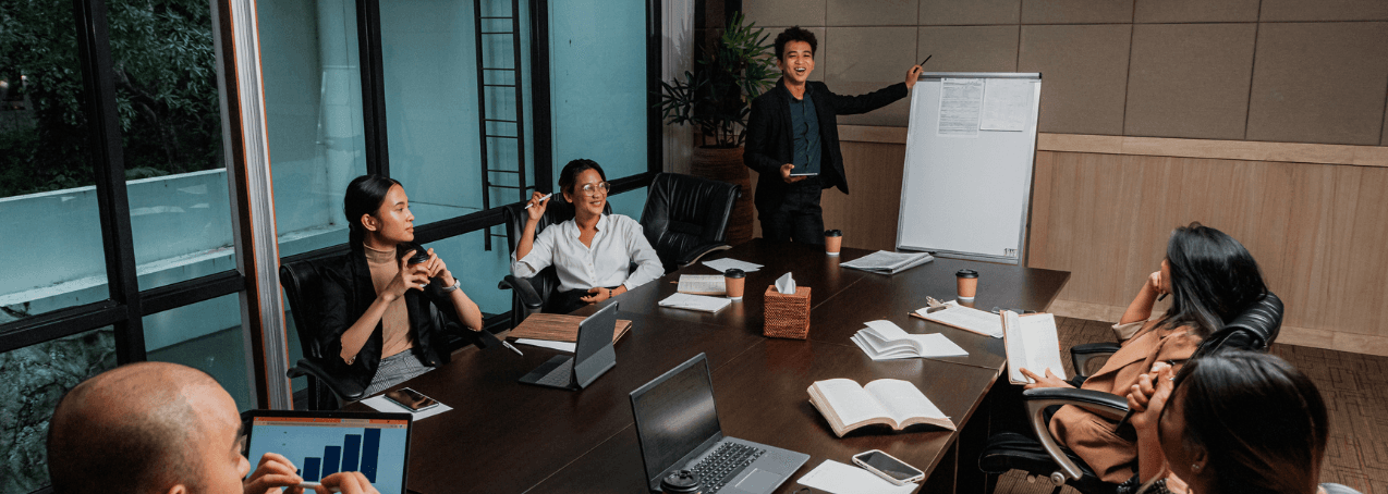 Our team in a business meeting, collaborating to connect car buyers with trusted dealers